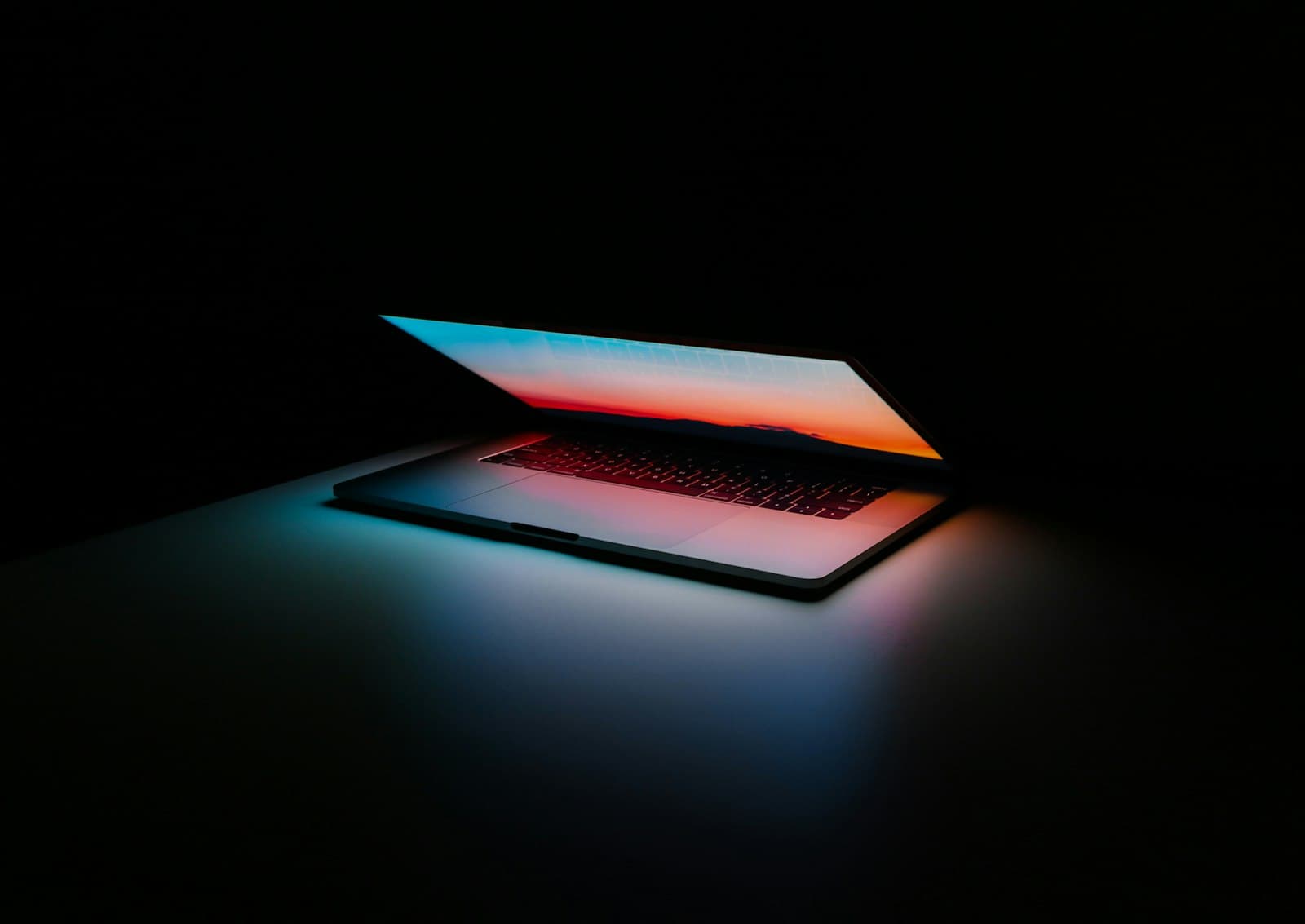 A laptop glowing in the dark, symbolizing performance