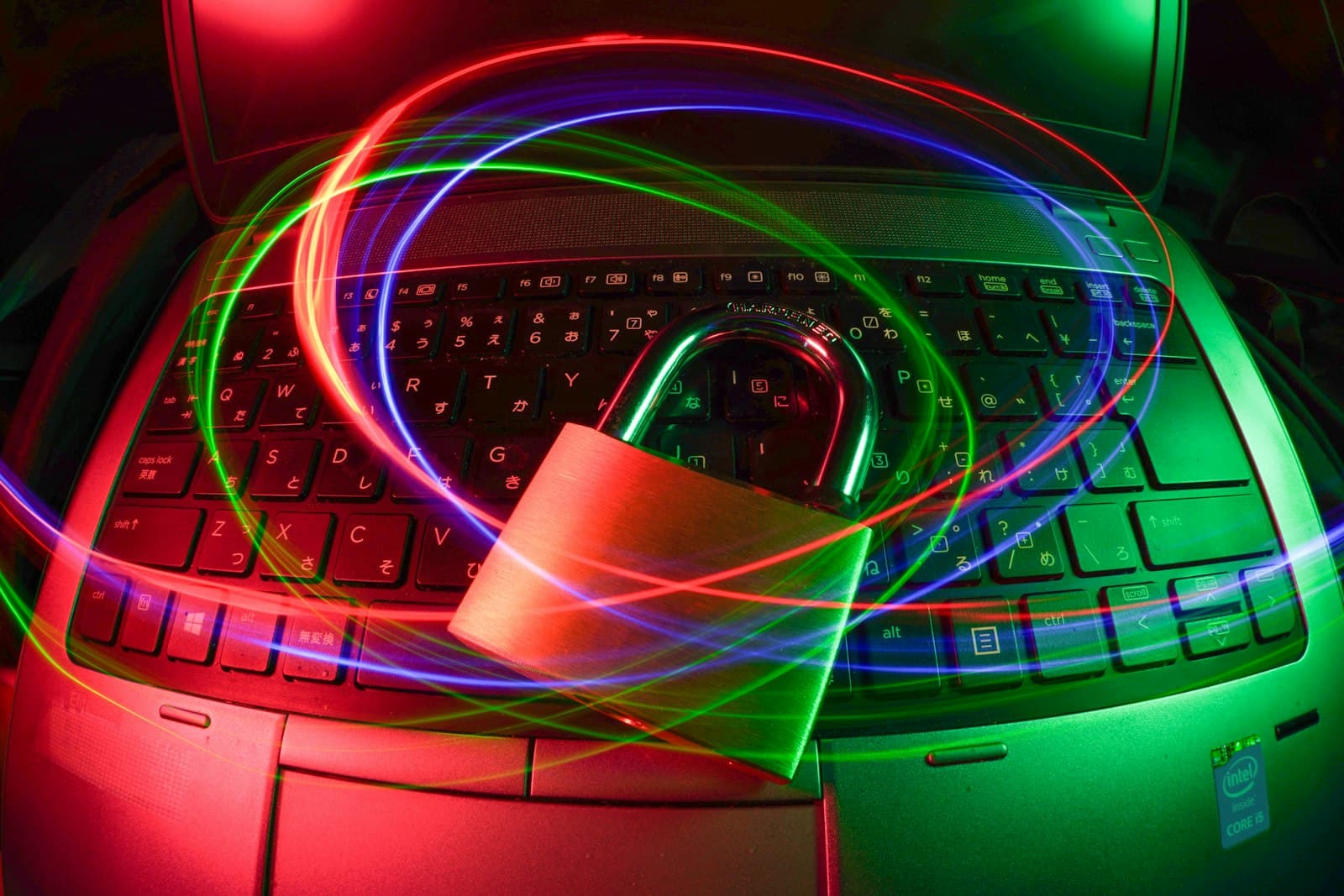 A padlock on a laptop keyboard with light trails