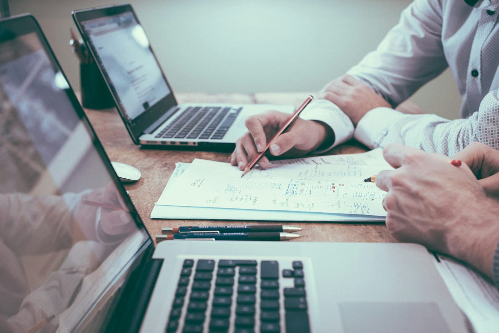 Planning website costs at a desk with a laptop and notes